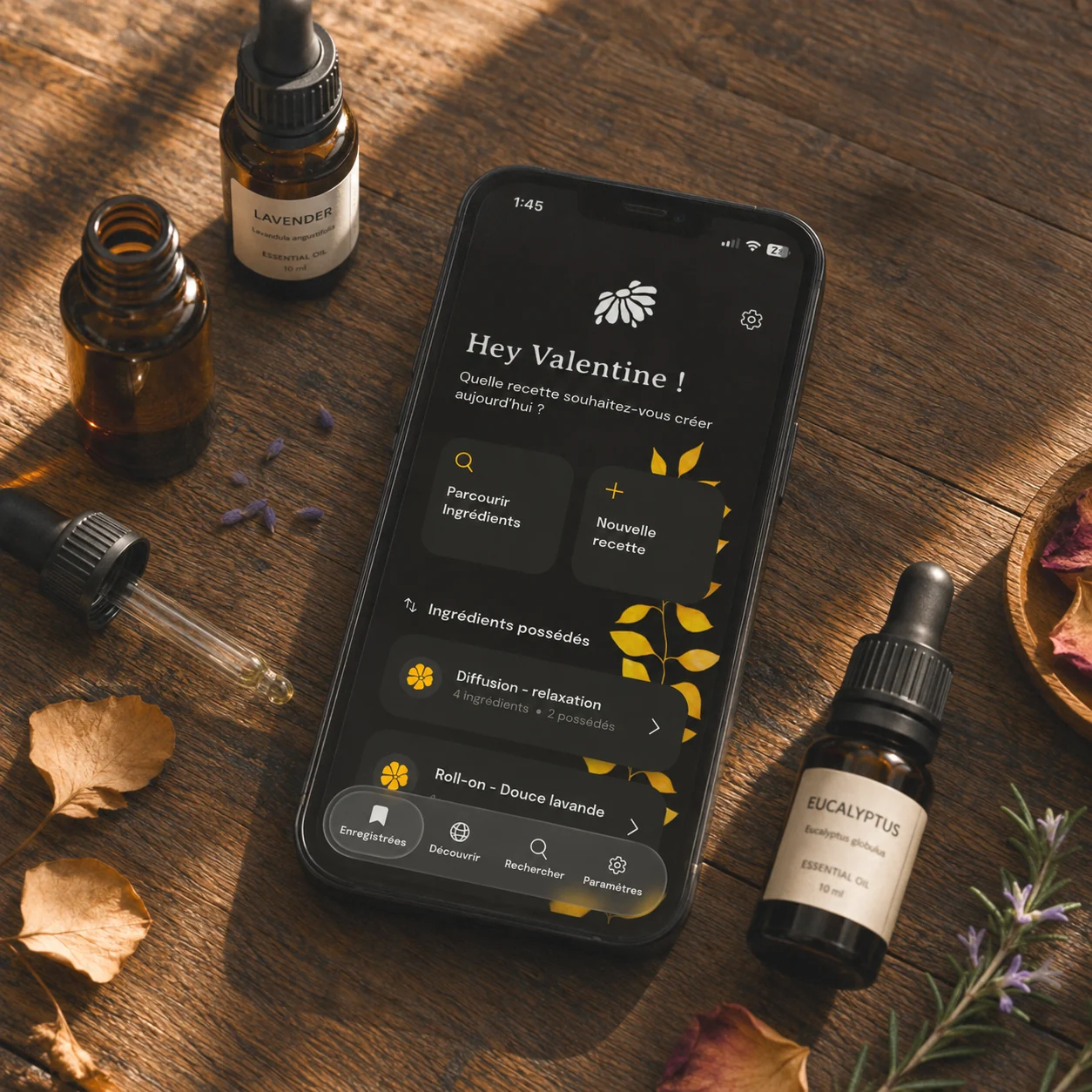Essential Blend ouvert sur un iPhone, à côté de flacons d’huiles essentielles