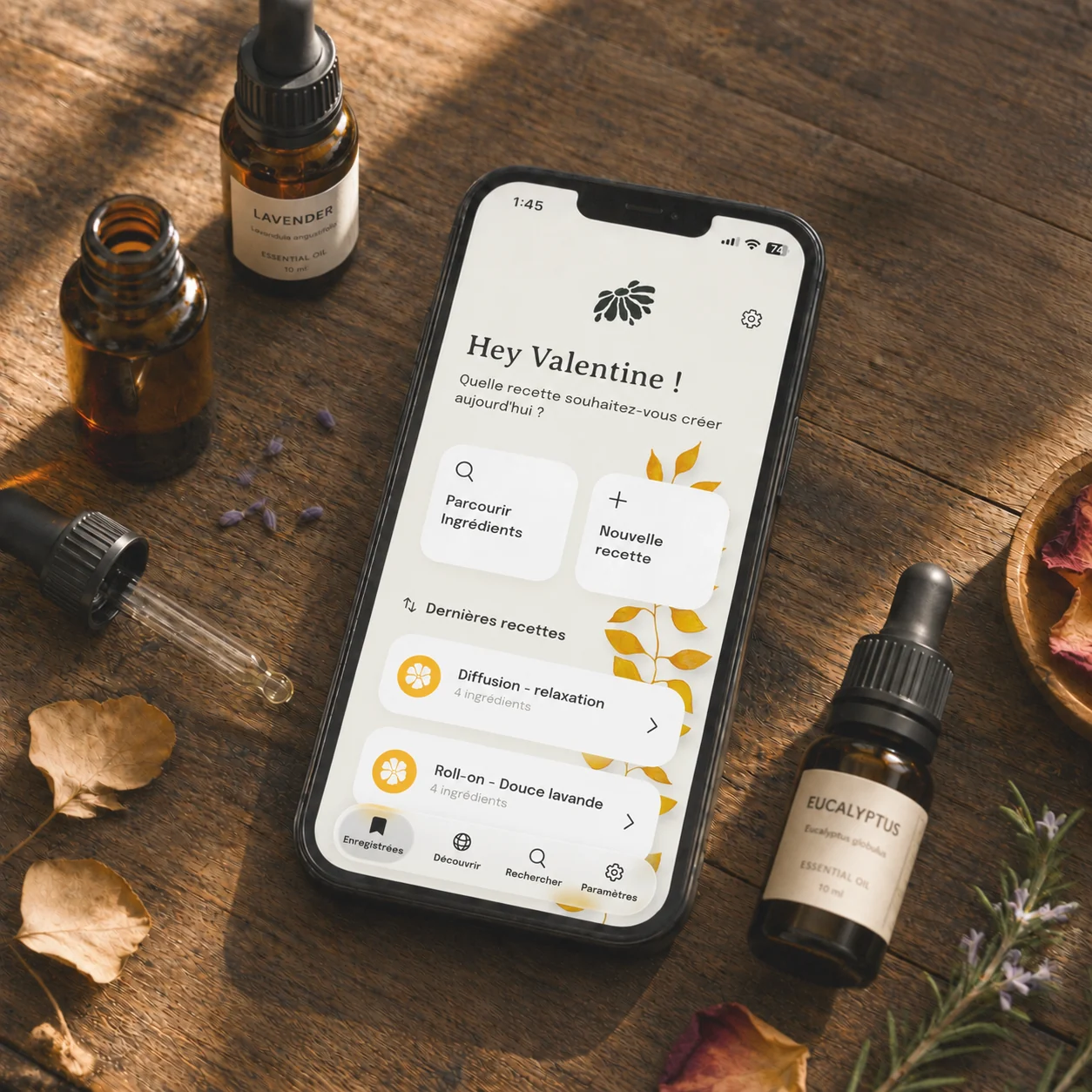 Essential Blend ouvert sur un iPhone, à côté de flacons d’huiles essentielles